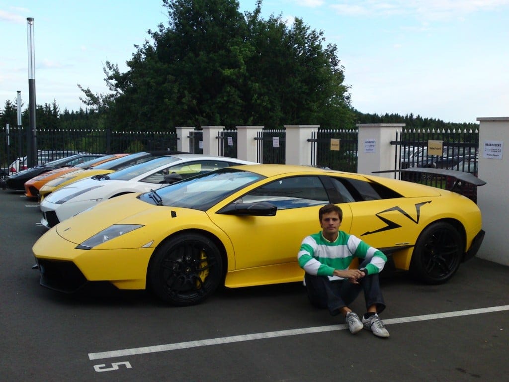 Ignacio Milán sitting in front of a yellow Lamborghini Murciélago SV