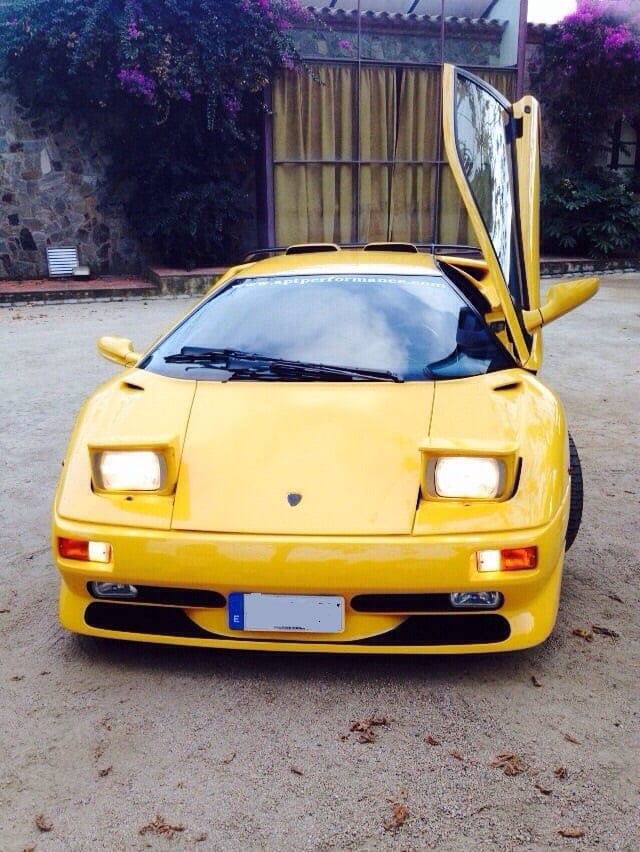Yellow Lamborghini Diablo with its scissor doors open