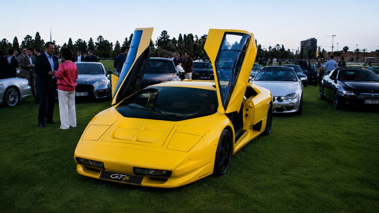 Yellow Lamborghini Diablo with scissor doors open at a GTlife gathering